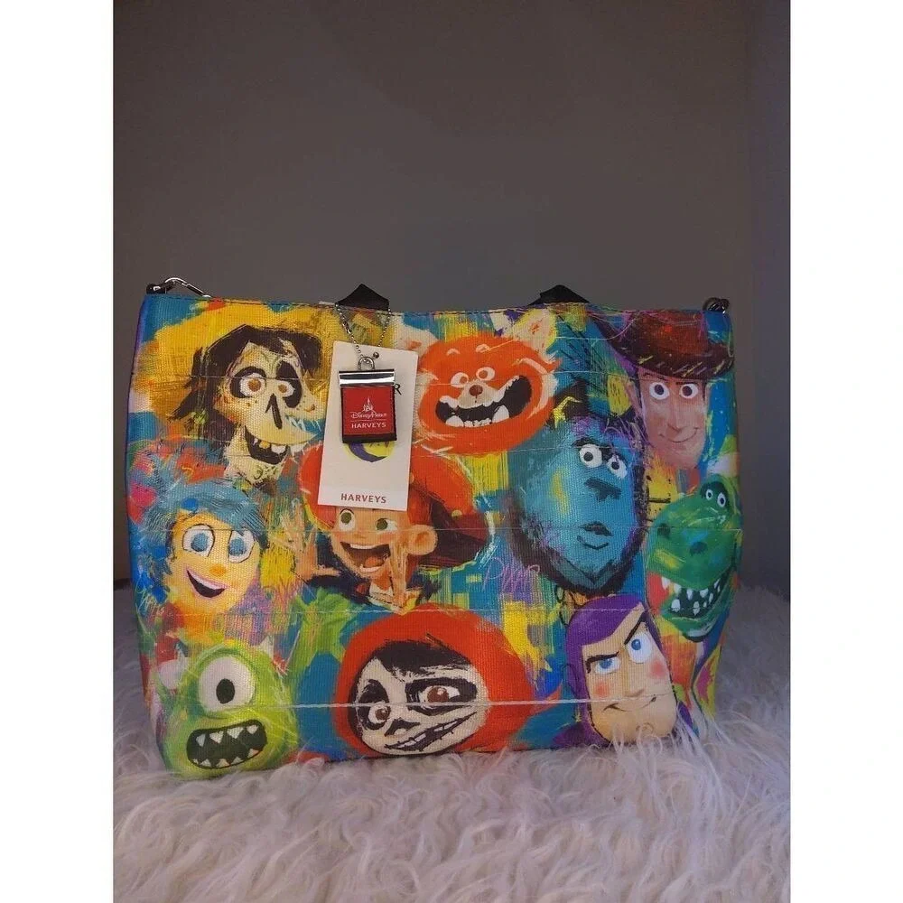 Harveys Disney Parks Pixar Seatbelt Tote Bag Purple Multi Toy Story Monsters Inc